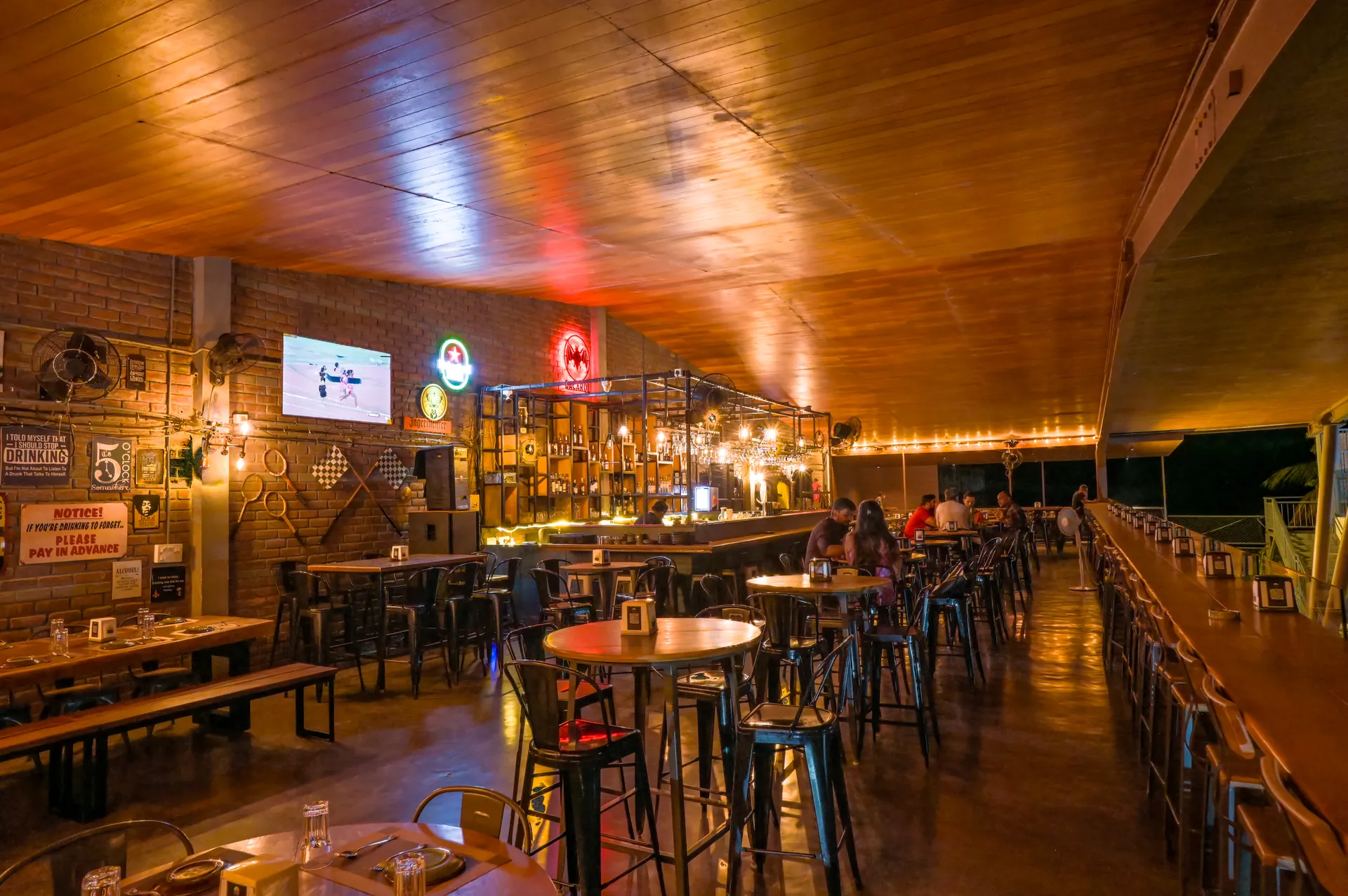 Mysore Union warmly lit bar dining space after dark