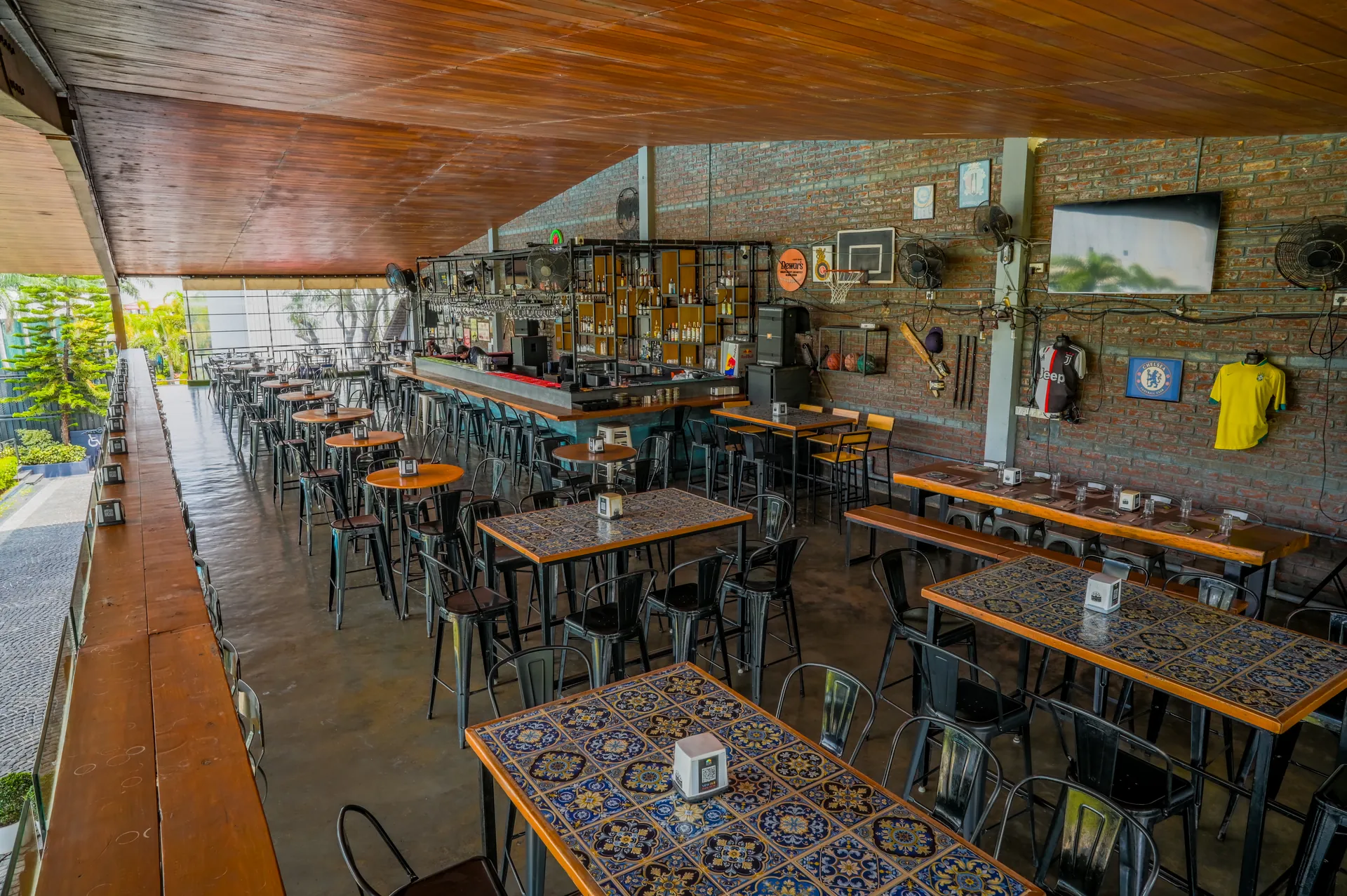 Mysore Union bar room with long counter and dining tables in Hebbal Mysuru
