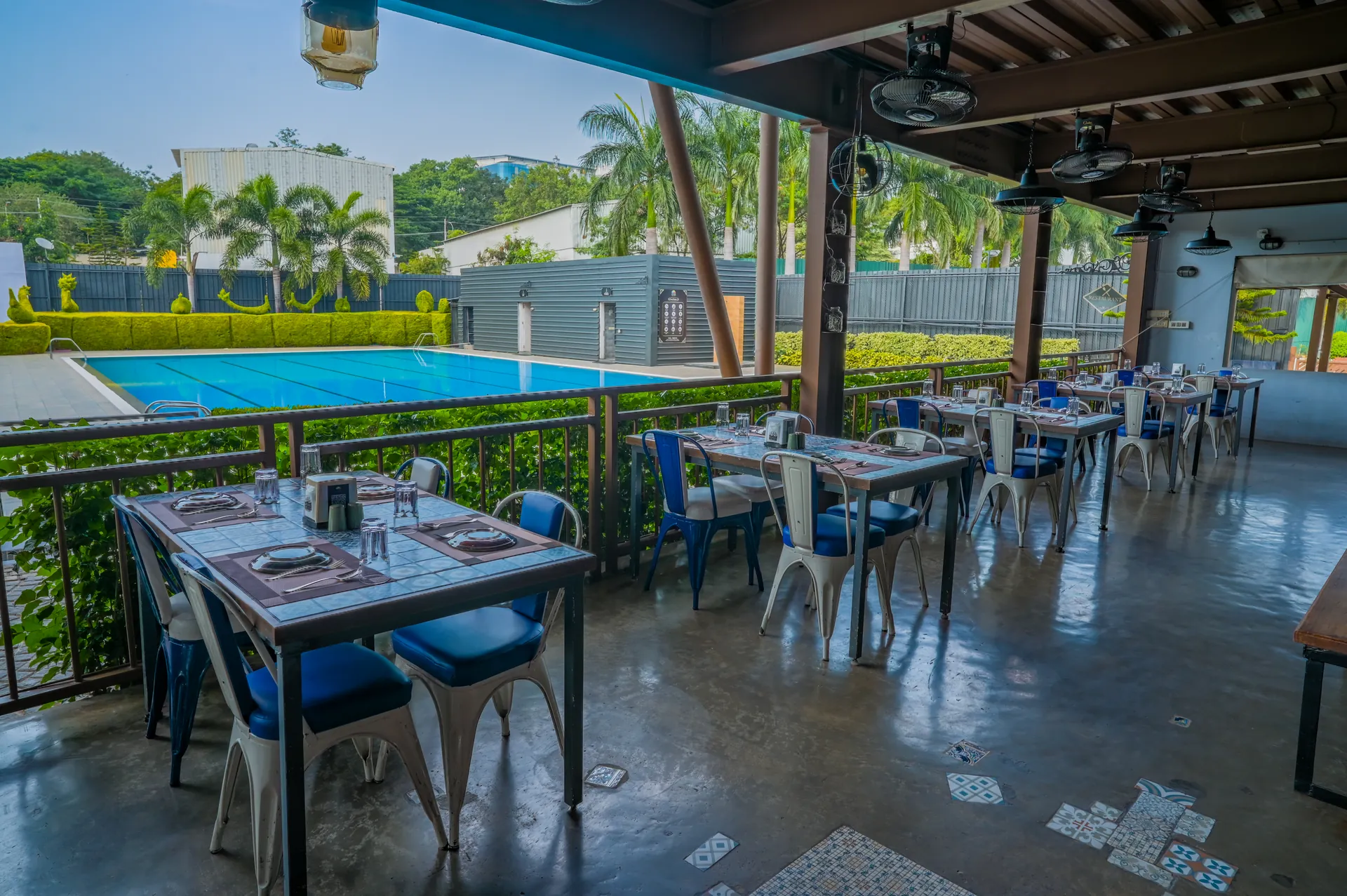 Outdoor dining beside swimming pool at Mysore Union Mysuru