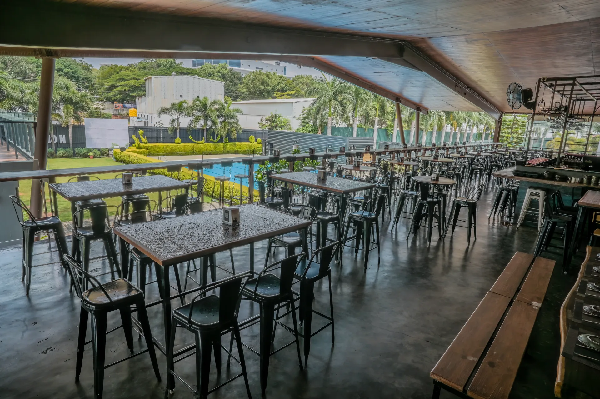 Open-air poolside restaurant seating at Mysore Union Mysuru